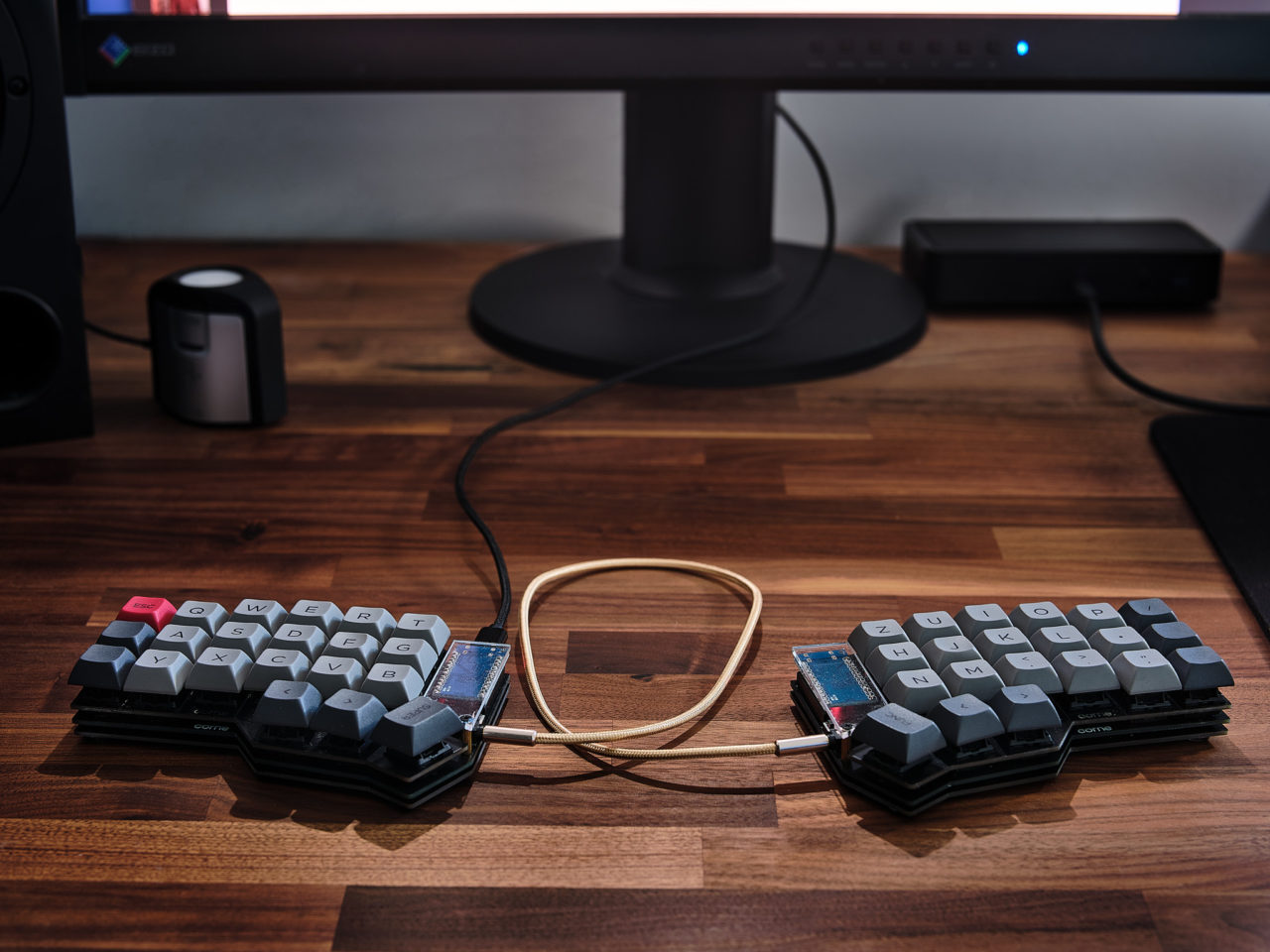 Corne Ortholinear Keyboard on a wood desk